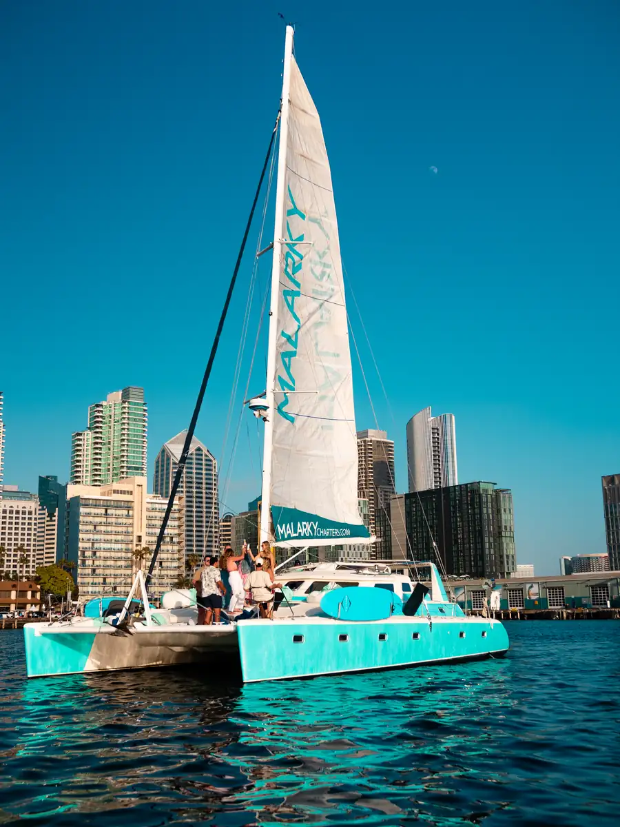 Aerial view of Malarky sailing San Diego Bay with downtown skyline behind