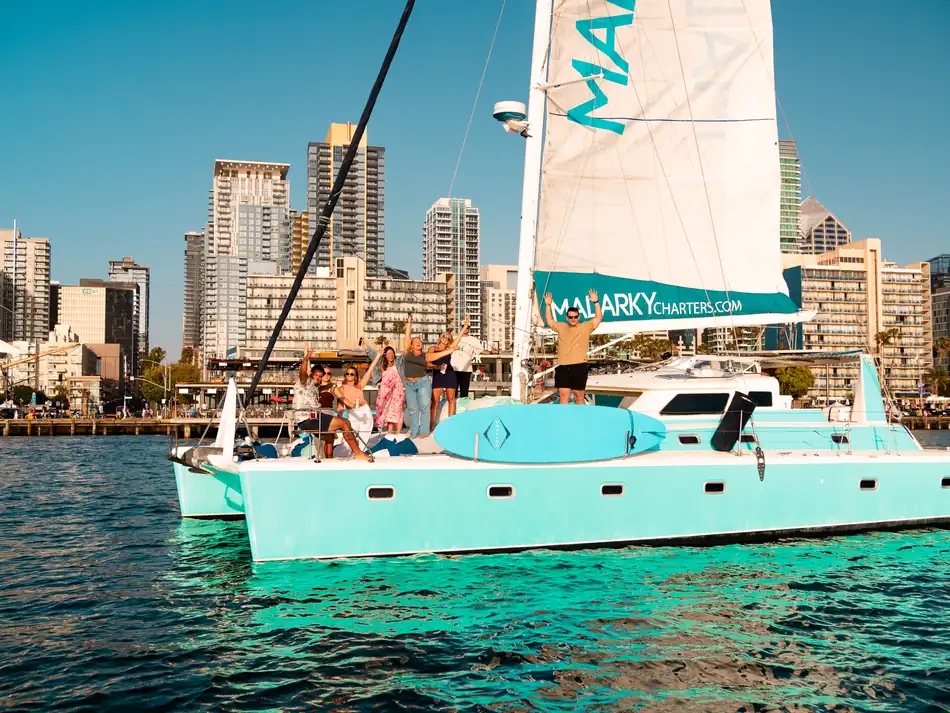 Malarky 47ft Voyage catamaran with private group on the bow and downtown San Diego skyline