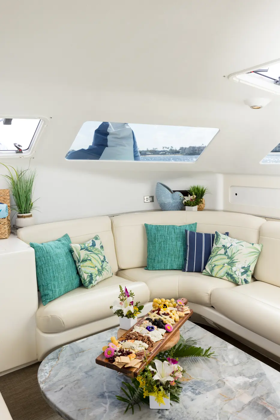 Malarky's indoor lounge corner with a charcuterie spread on the marble table for an anniversary charter