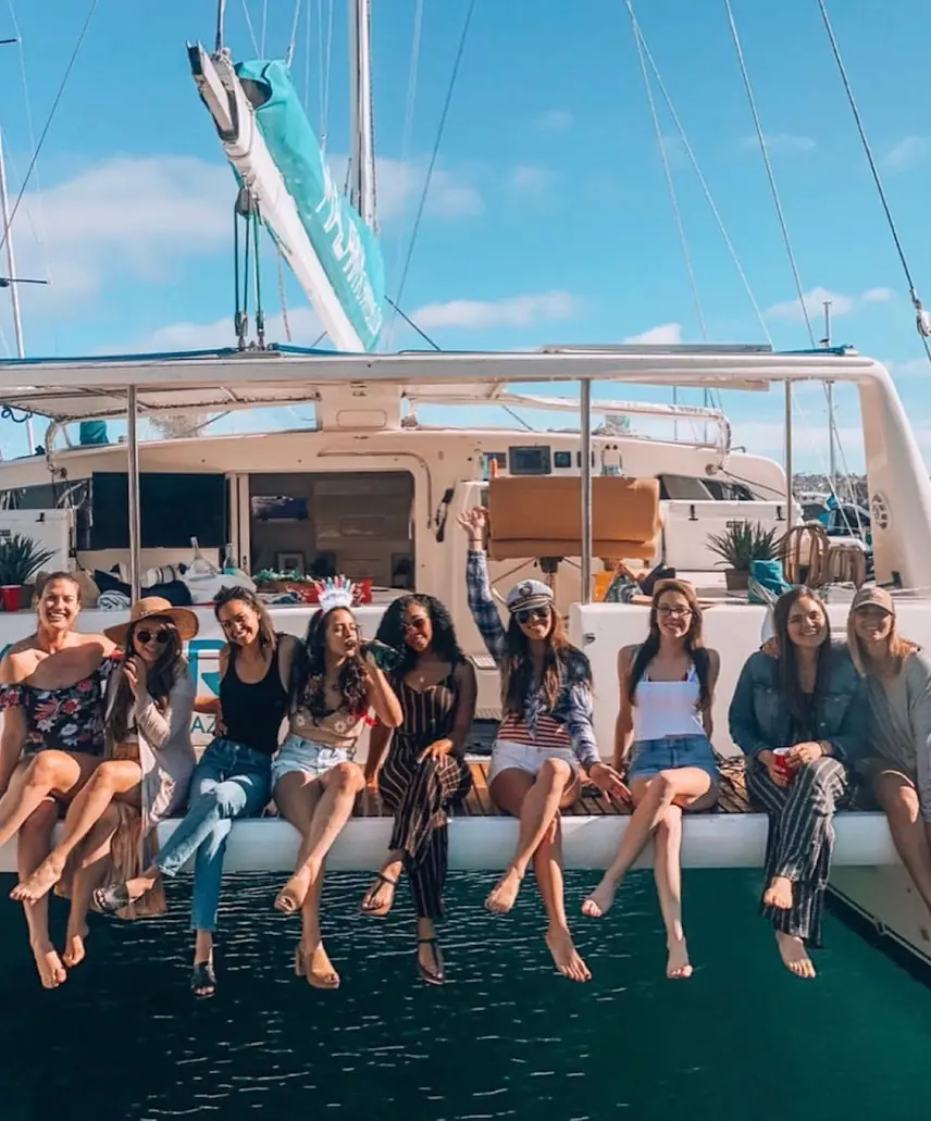 Bachelorette party aboard Malarky's aft deck with the bride wearing a captain's hat