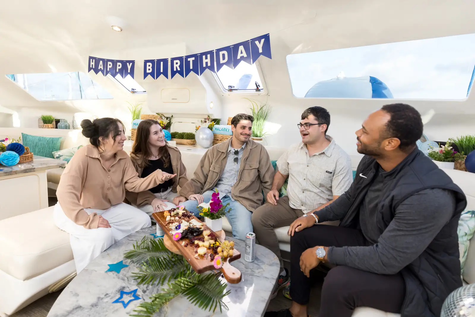Birthday party in Malarky's indoor lounge with Happy Birthday banner and friends celebrating